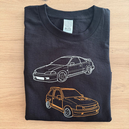 Black t-shirt with car designs on a wooden surface
